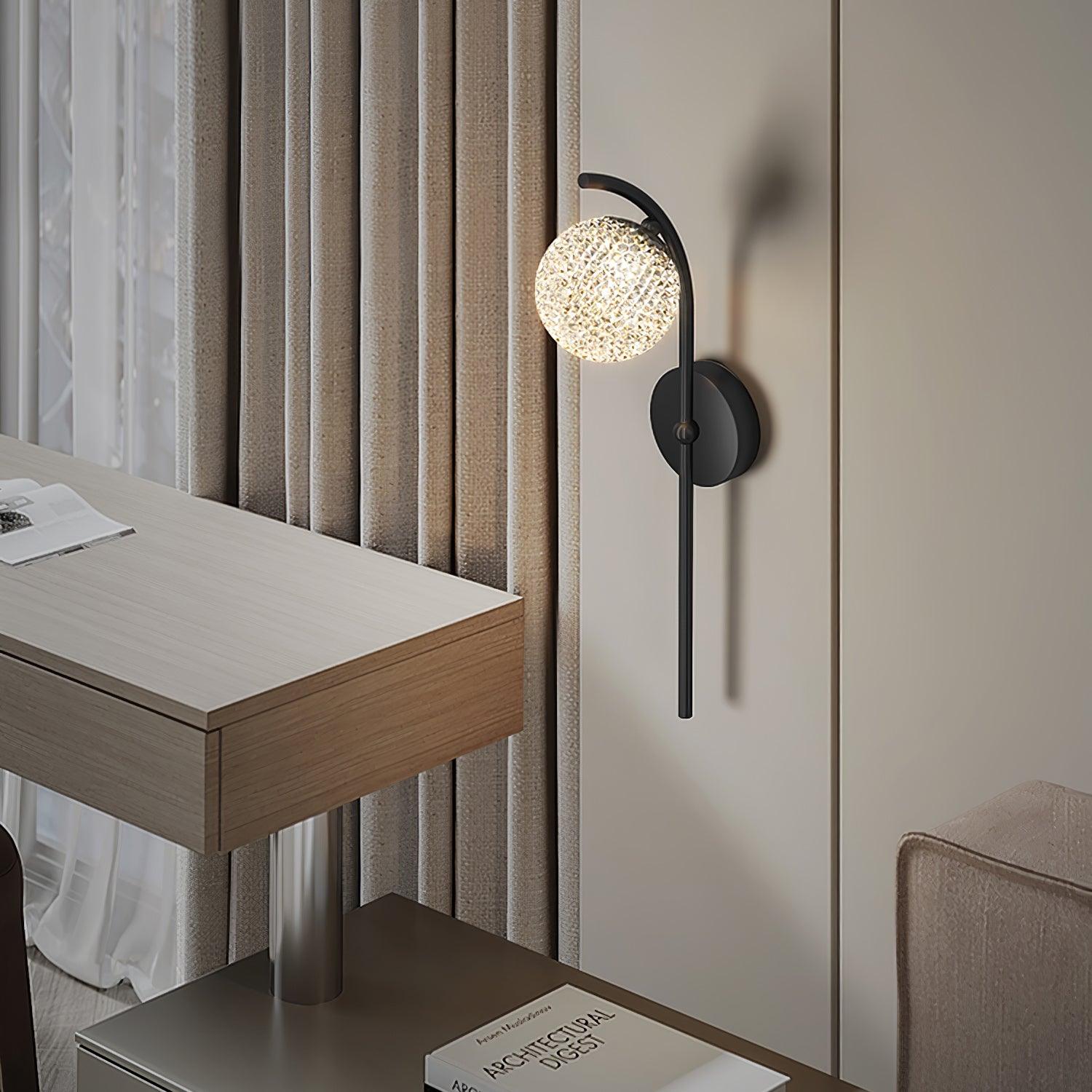 Black curved wall light beside a desk and window