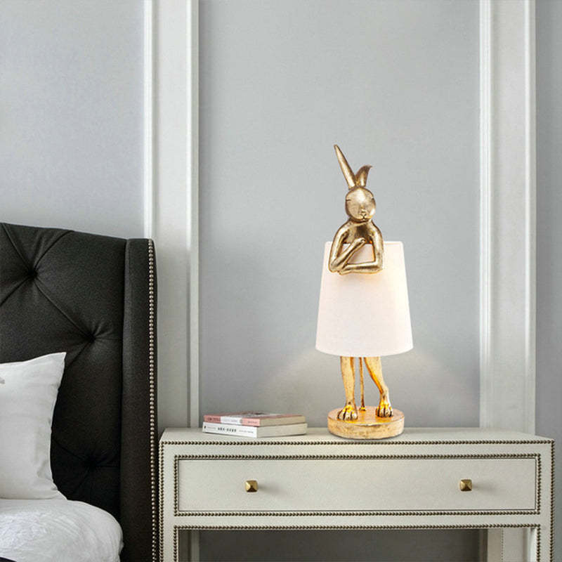 Gold rabbit lamp on a bedside cabinet