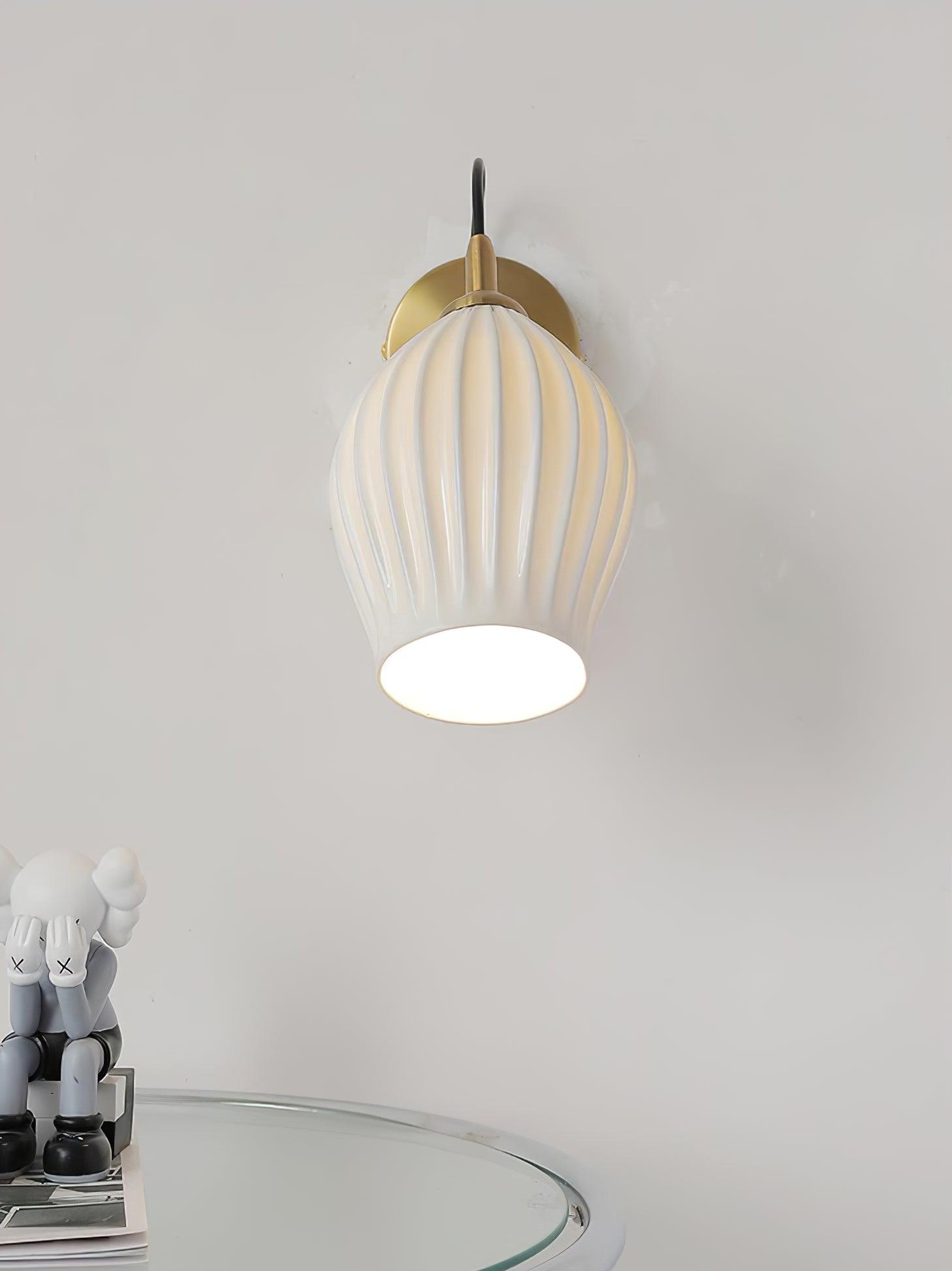 Front view of a glowing ceramic wall shade