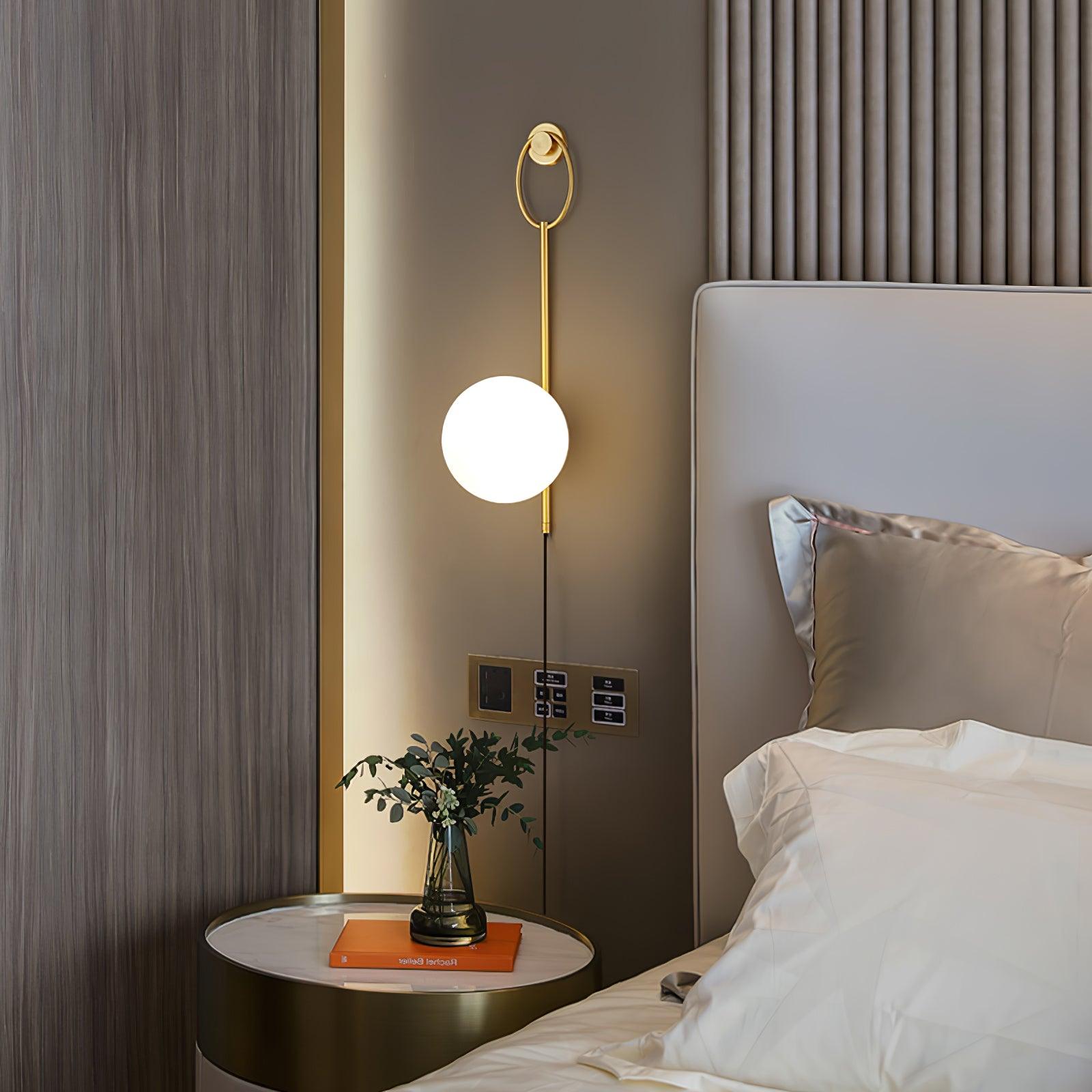 Glowing Ballon globe beside a bedroom headboard
