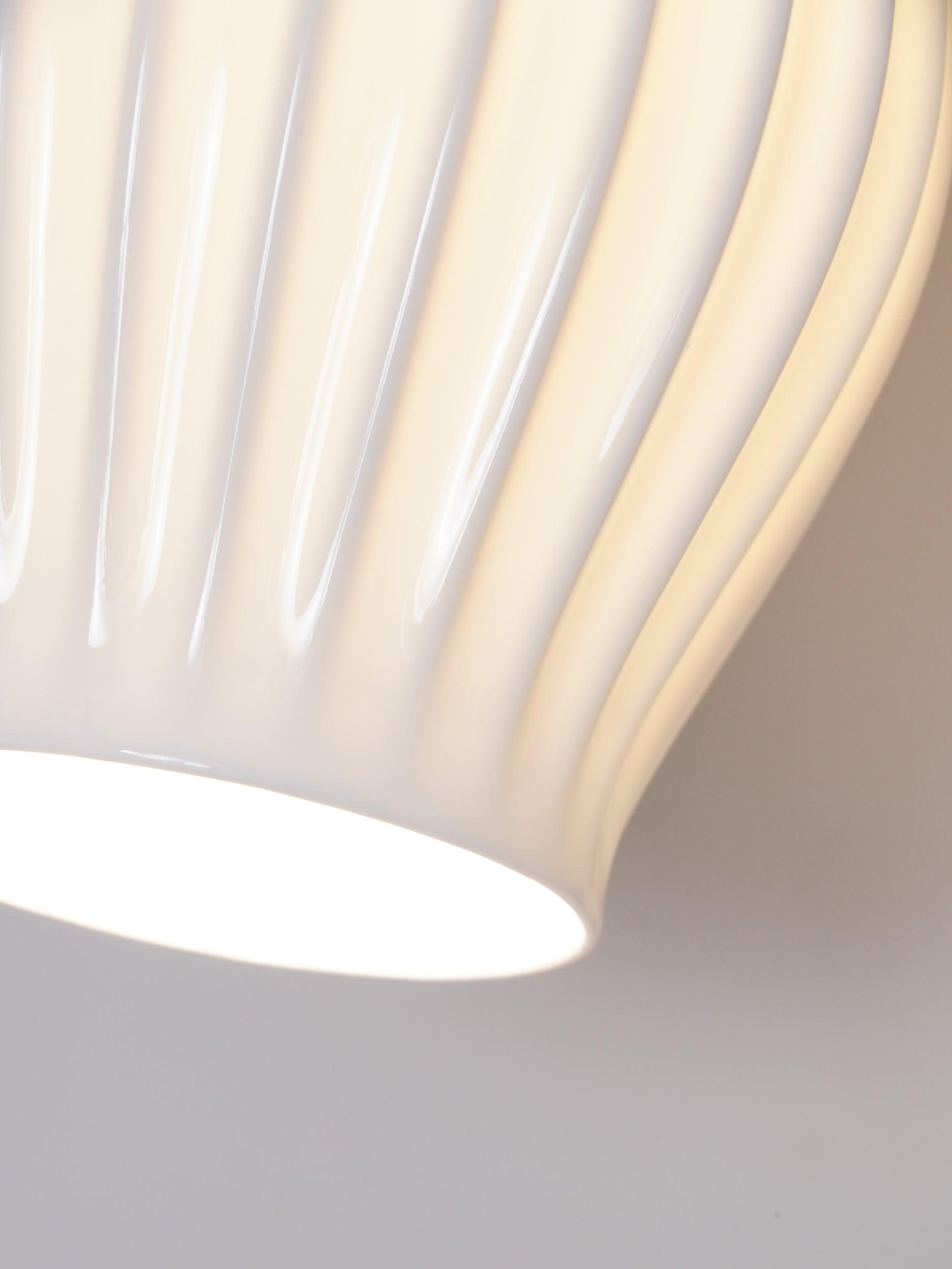 Close-up of glossy ceramic ribs and glowing lower opening