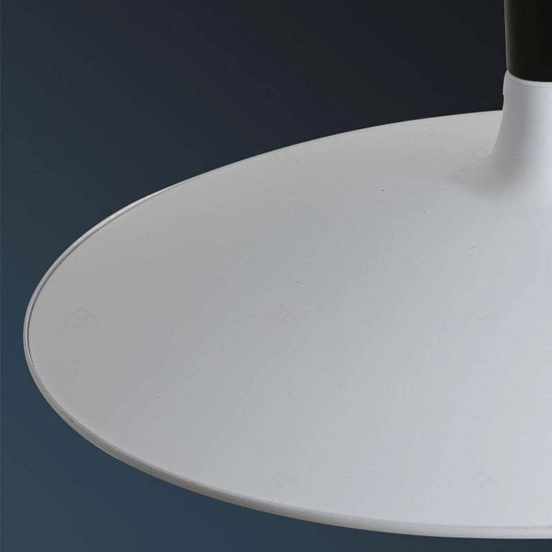 Close pale curved upper shade surface and thin raised rim against a dark background