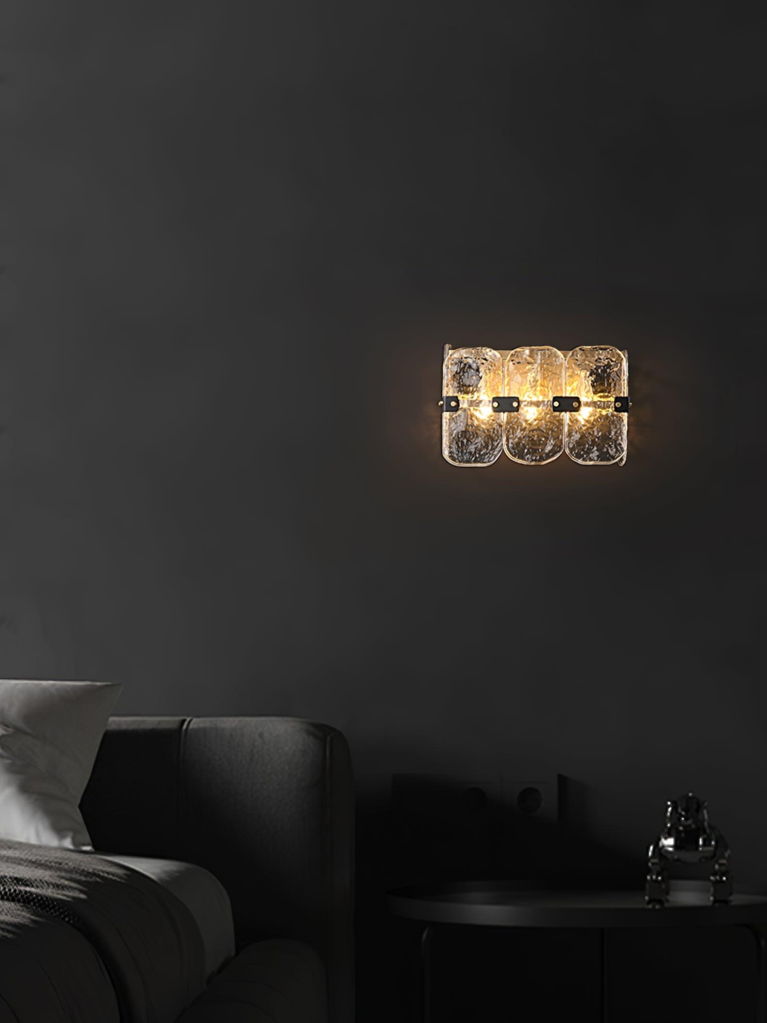 Textured glass wall light in a dark indoor seating area