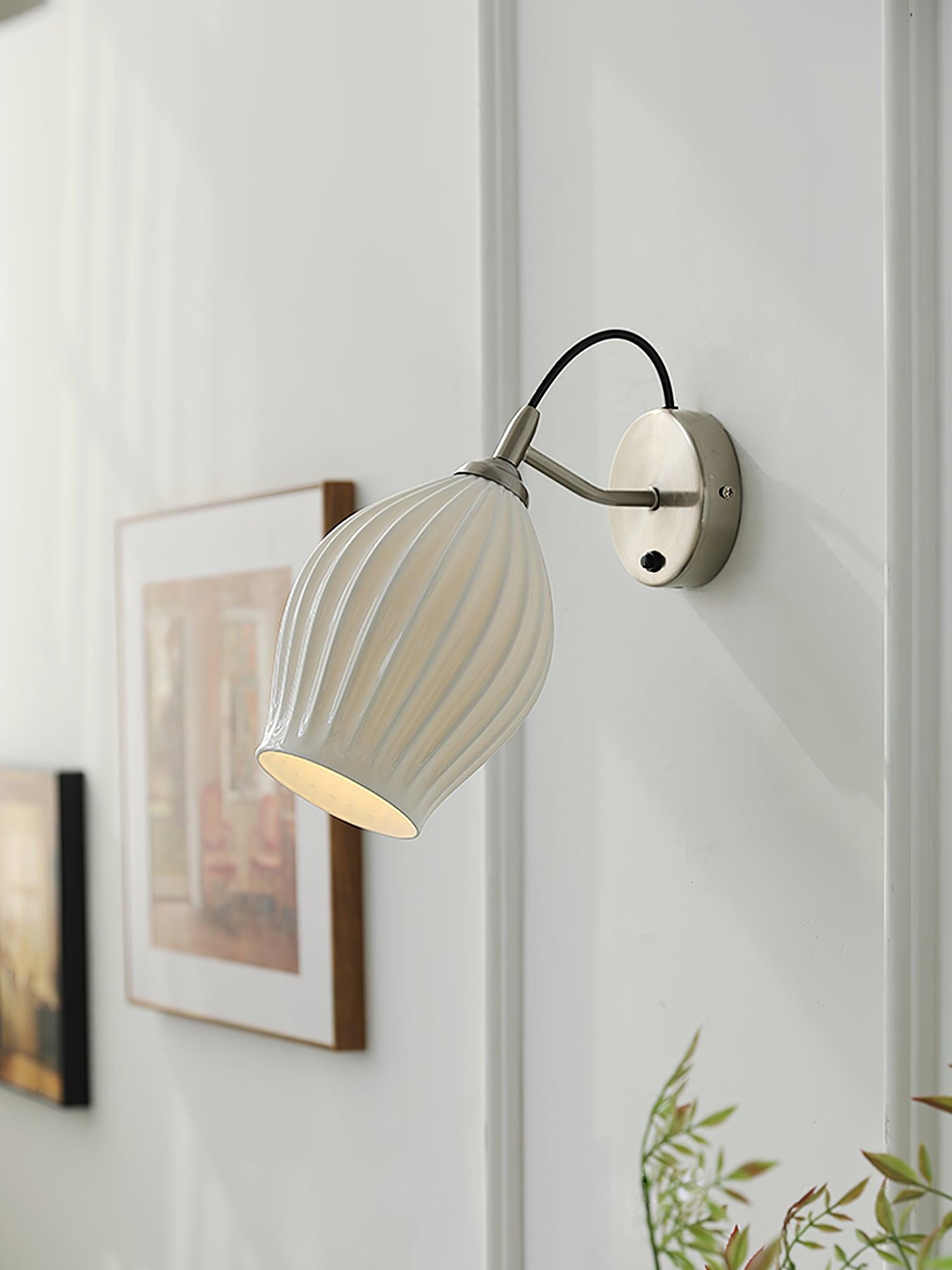 Sand-nickel wall fitting above artwork and plants