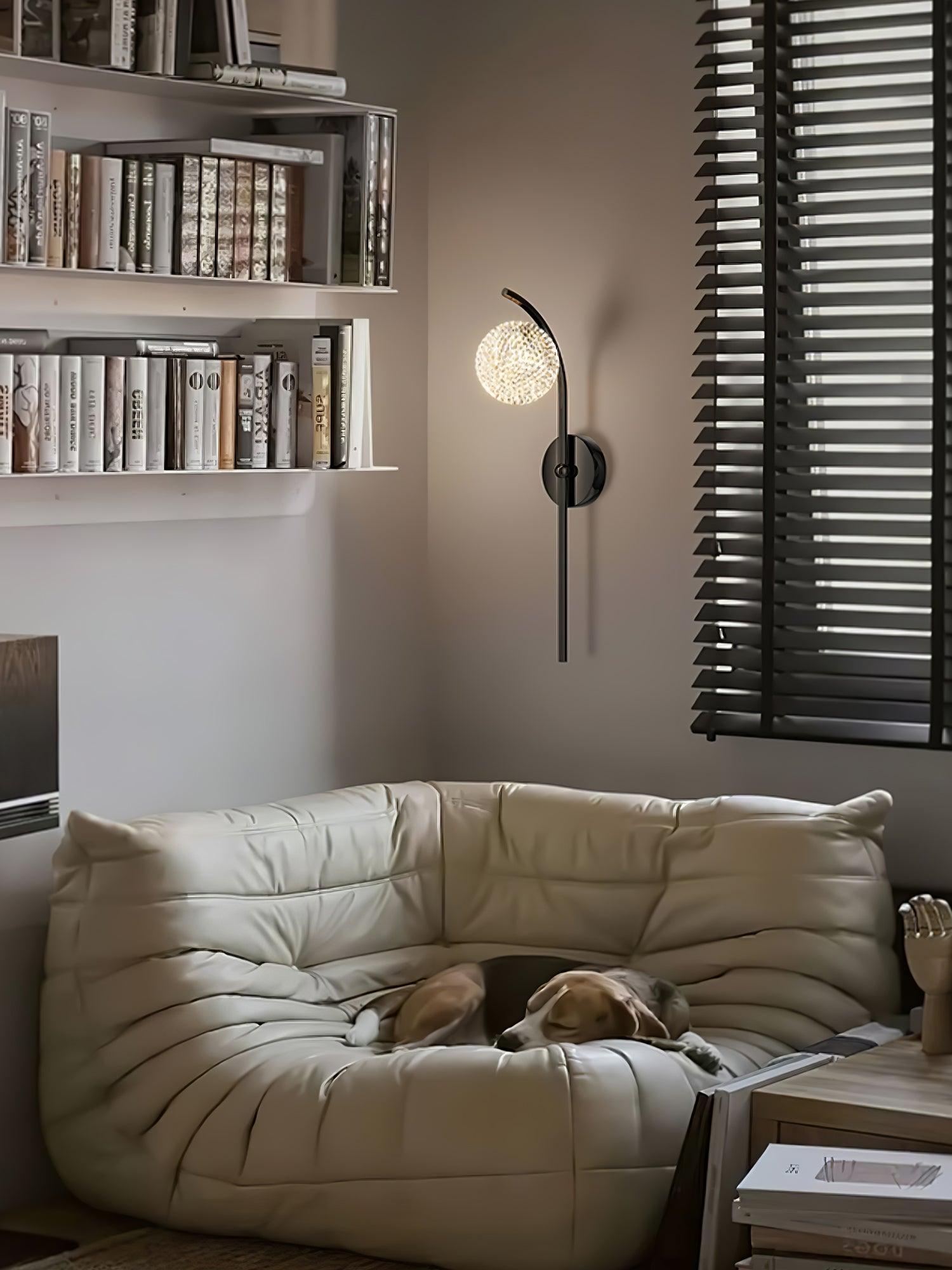 Black curved wall lamp beside a sofa and shelves