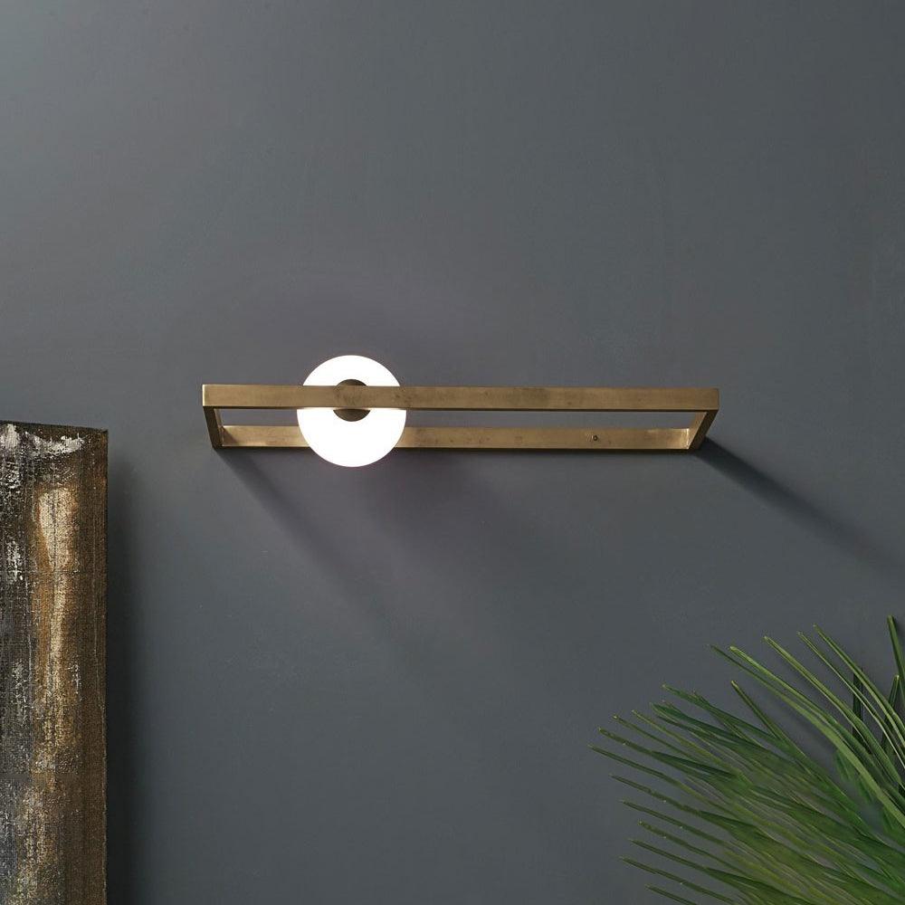Horizontal Mondrian wall light beside framed art