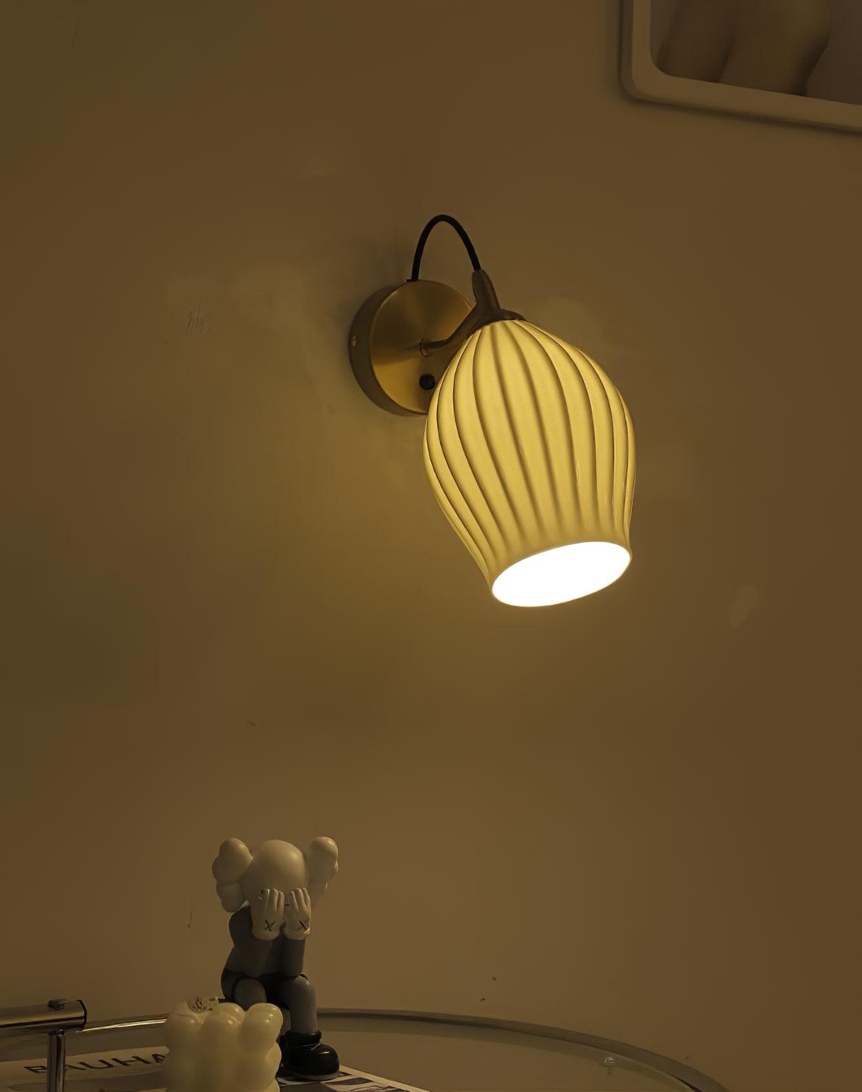 Angled ribbed shade glowing against a darkened wall