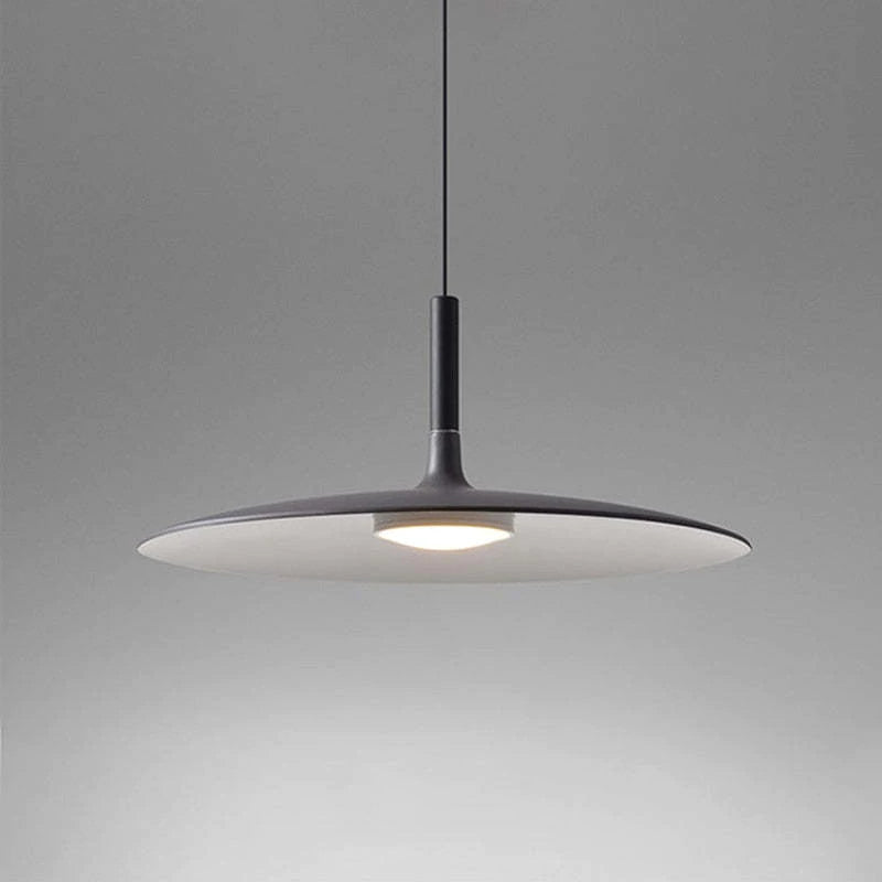 Close dark shallow dome pendant with pale underside and a central glowing disc