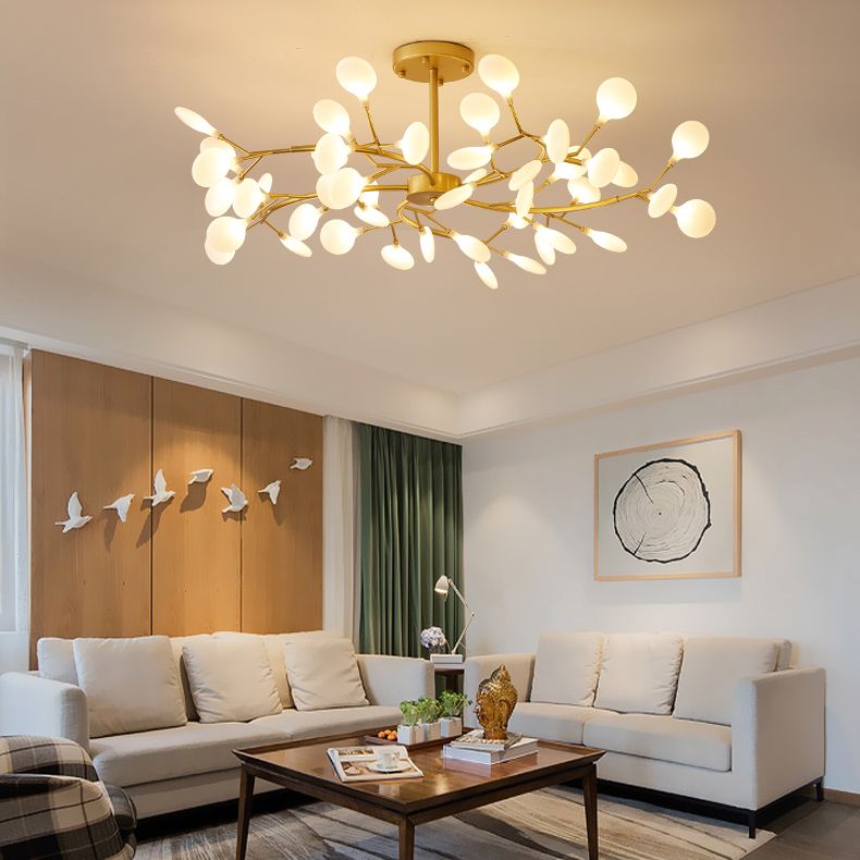 Olivia gold branch chandelier in a room with seating and wall art