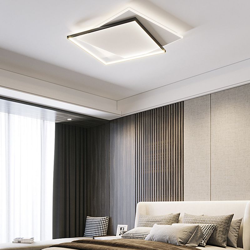 Quinn overlapping square ceiling light above a pale padded bedhead, patterned cushions, wood slat wall and grey curtains.