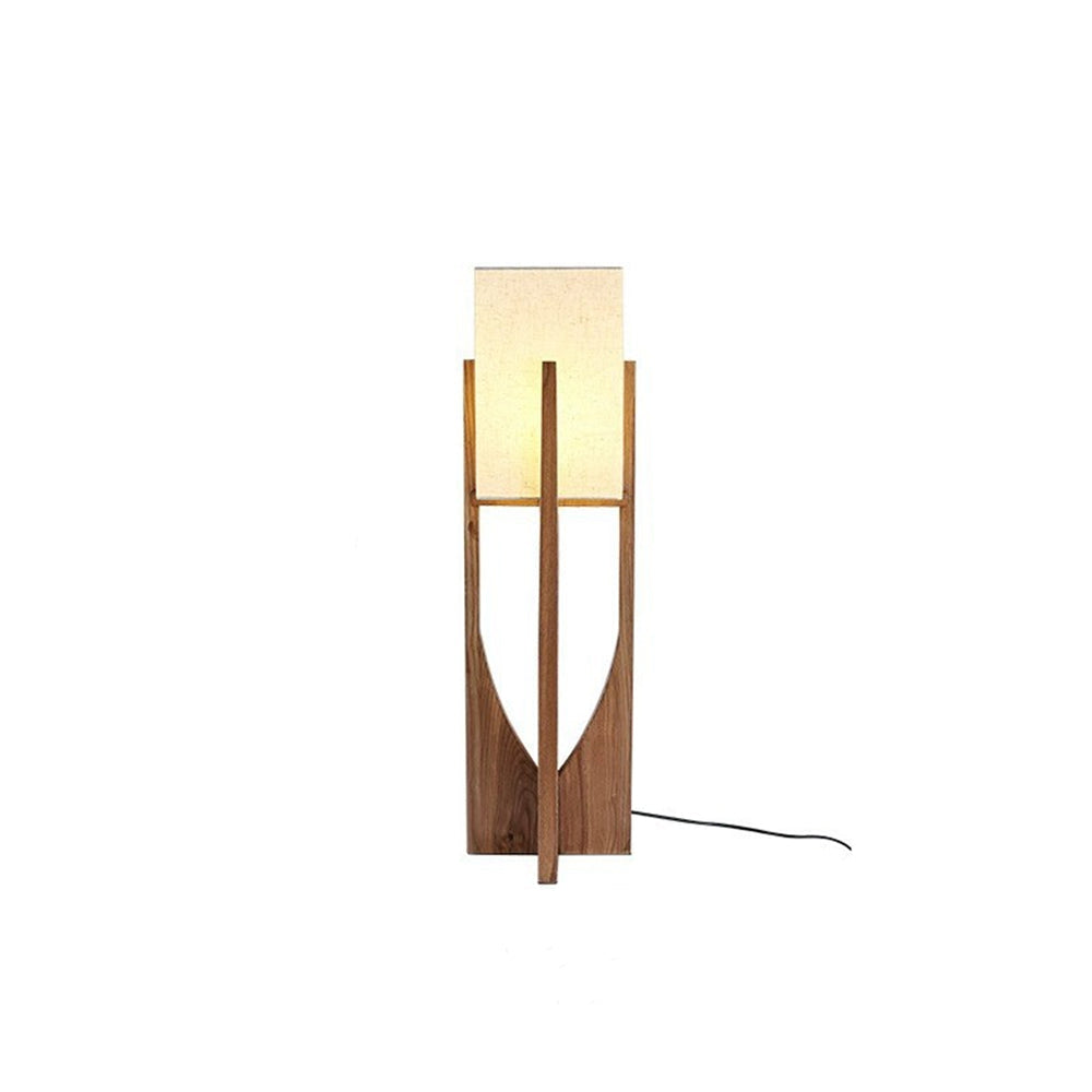 Isolated shorter walnut-tone Ozawa lamp, cream rectangular shade above curved crossed wooden panels, black cord trailing right