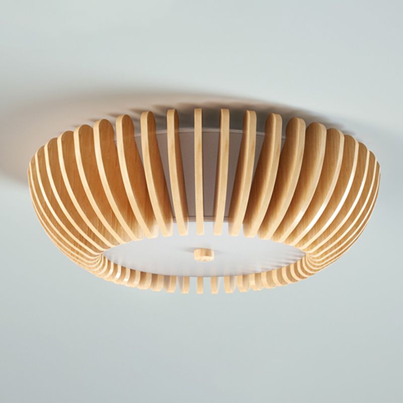 Unlit Ozawa detail showing curved wood-grain slats, a pale inner shade and round lower face with a central wood-tone cap.