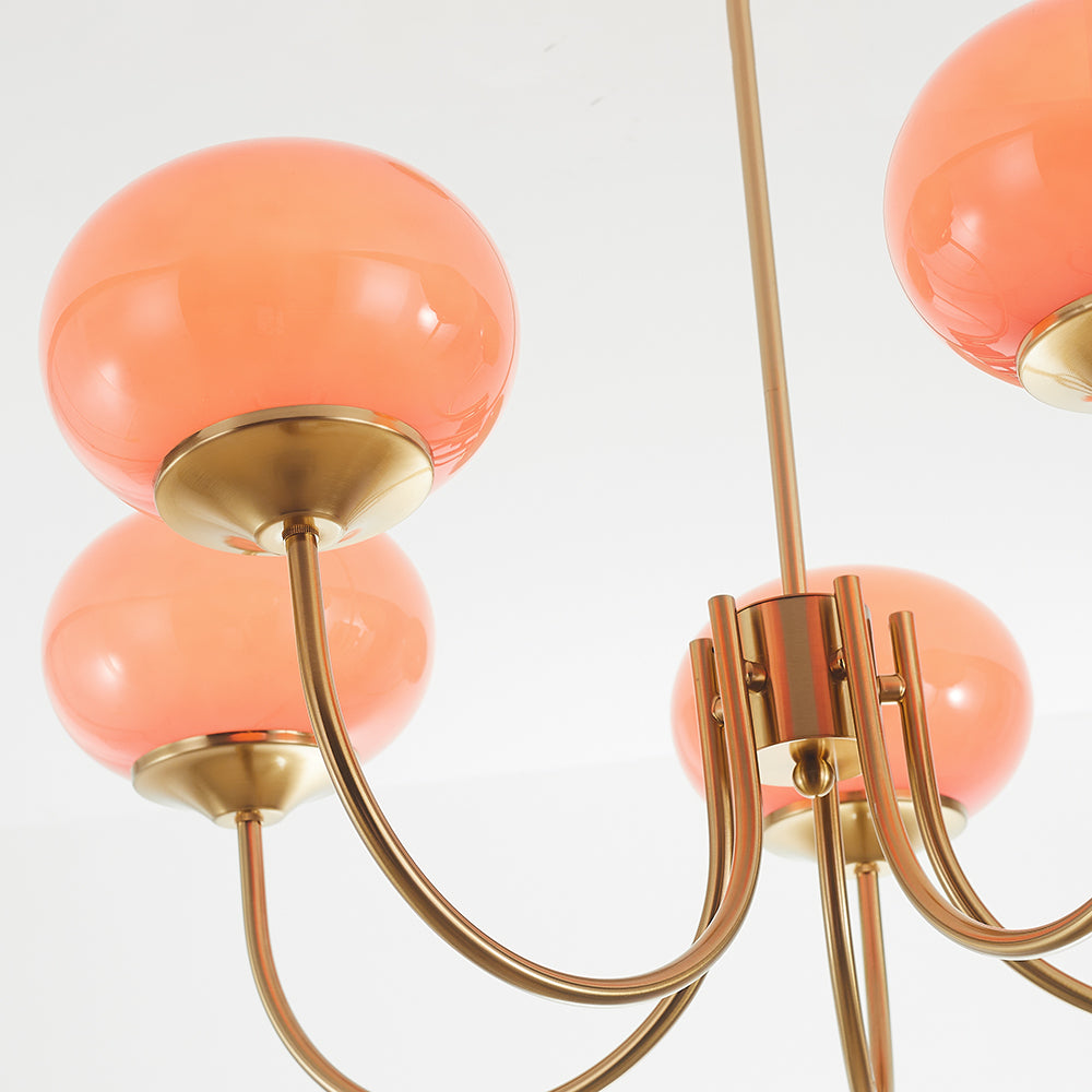 Low-angle detail of pink globes, shade cups and curved metal arms