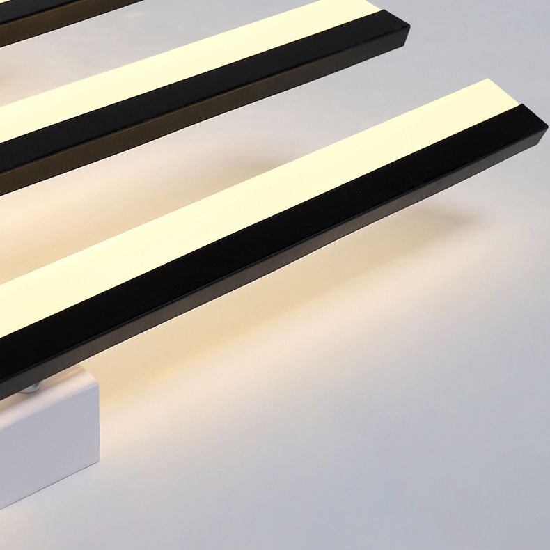 Quinn detail showing two black-edged bars, pale light faces and a corner of the ceiling base against a gray background.