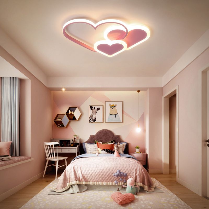 Pink heart-shaped Morandi ceiling light above a bed in a pink room.