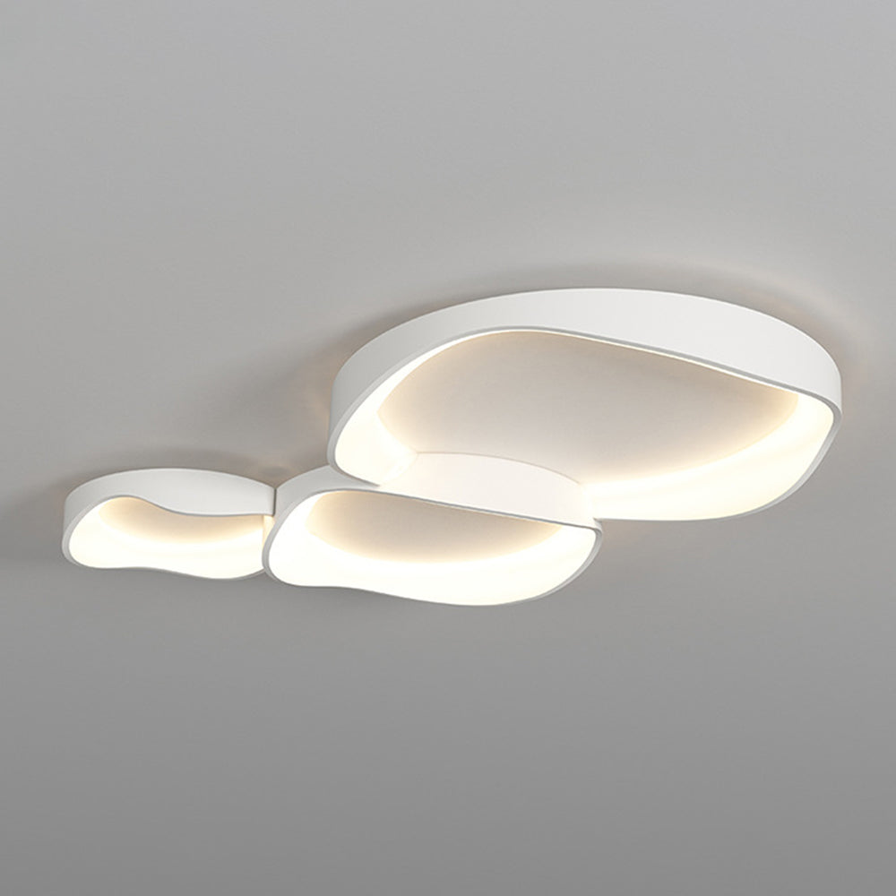 Three connected white Arisha bowls on a plain ceiling, with pale centres and warm-looking light around the inner rims.