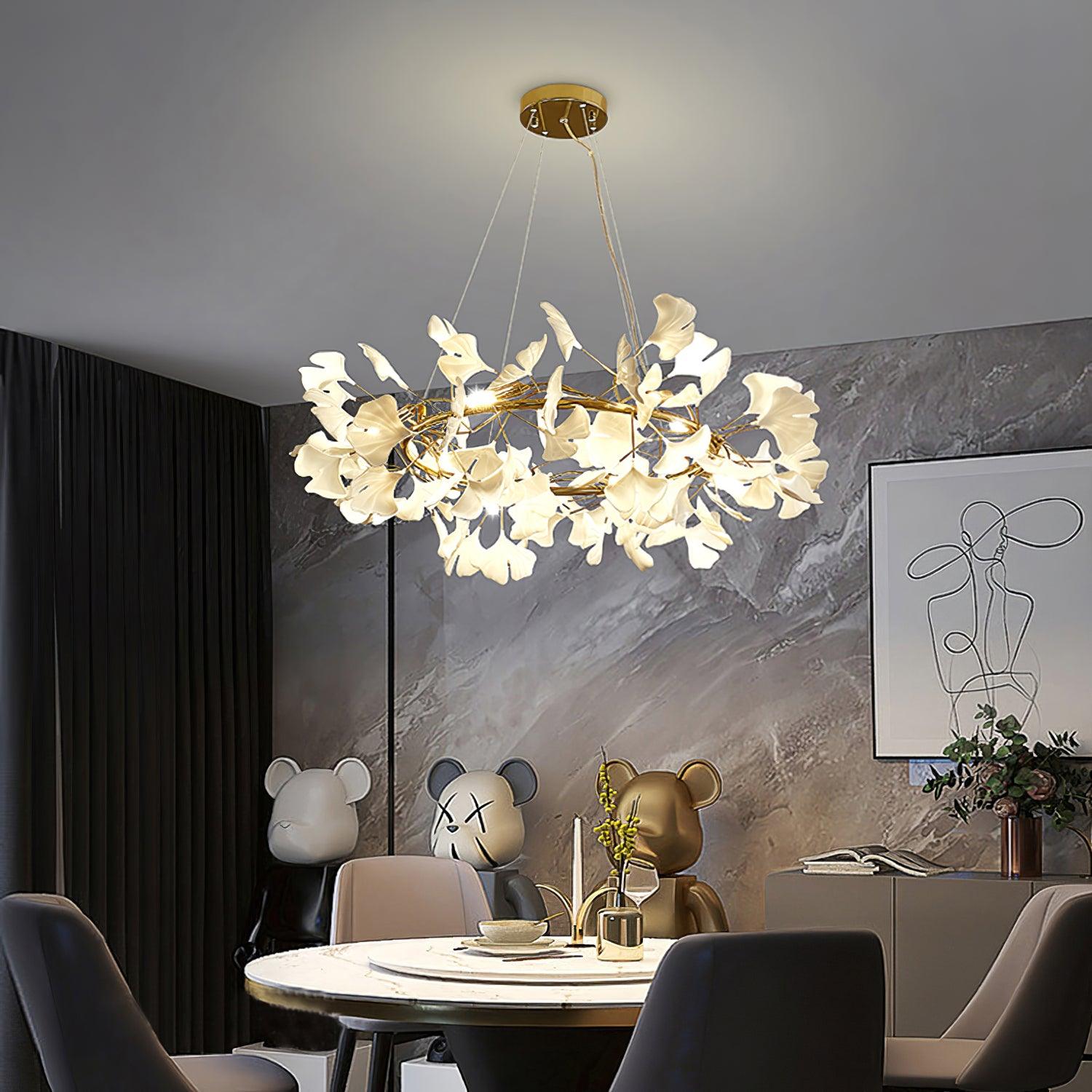 Gold-colour leaf chandelier above a round dining table