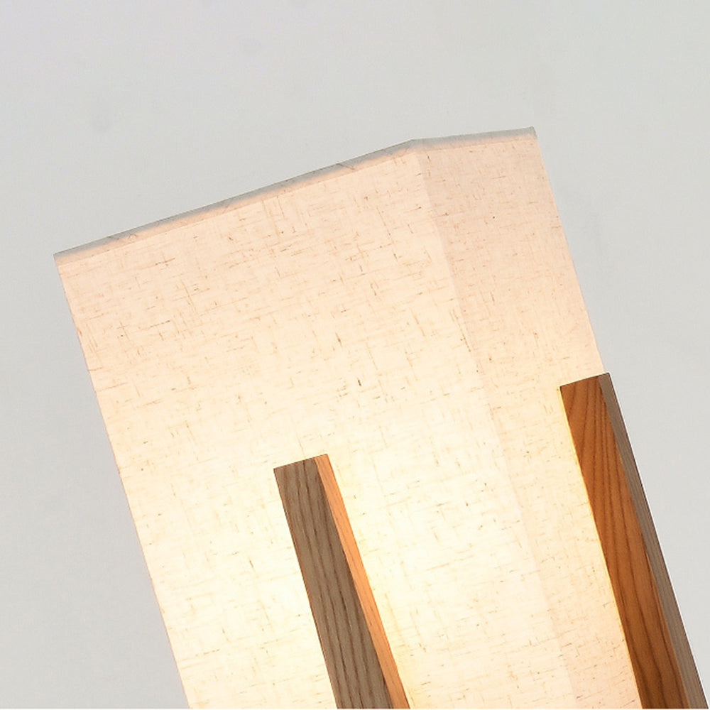 Close-up of glowing rectangular Ozawa shade, woven cream fabric texture and dark wooden support strips