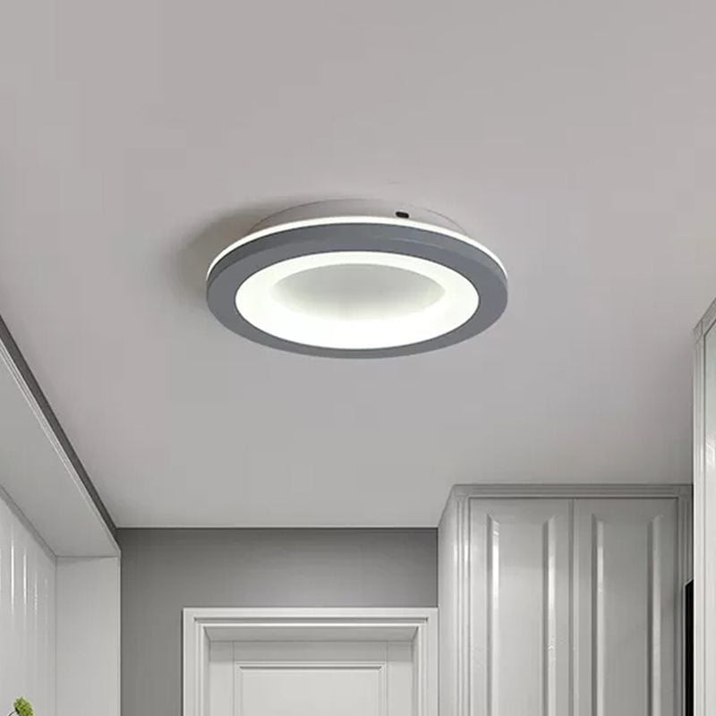 Circular gray ceiling light with a white-lit inner ring in a hallway