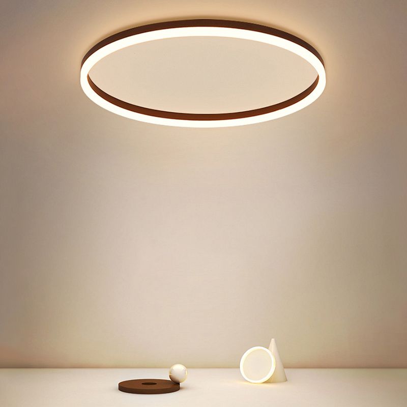 Quinn ring ceiling light glowing above a small table against a warm-toned wall.