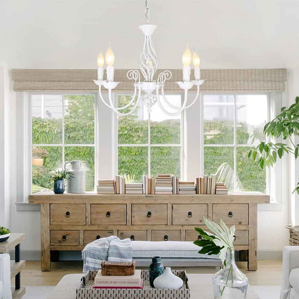 White Silva five-light chandelier in bright living area above bench and wooden sideboard with books, large windows behind