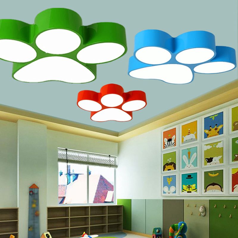 Green, blue and red Freja paw lights pictured in a colorful room