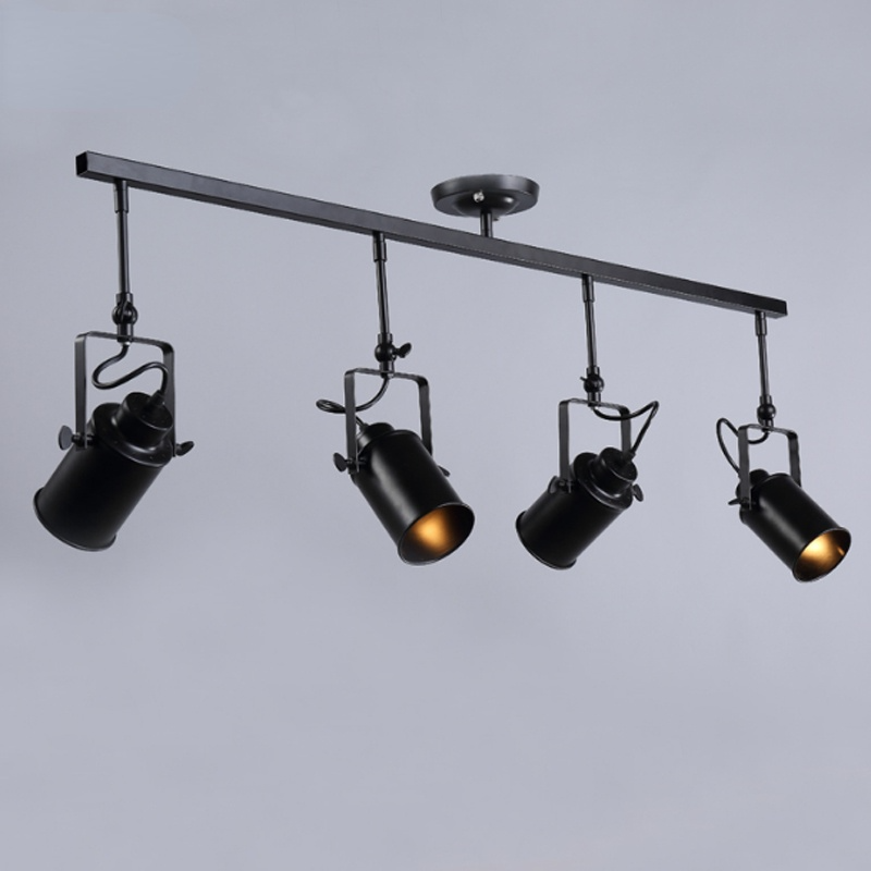 Alessio four-head black spotlight bar from the side, with cylindrical housings, square brackets and looped cables.