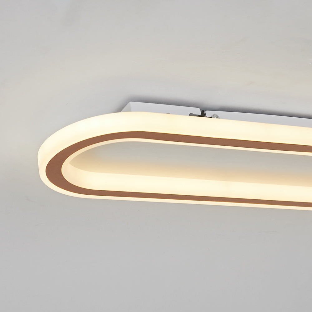 Rose Gold Quinn rounded-end close-up with illuminated borders and visible ceiling-side strip, screw and clip detail.