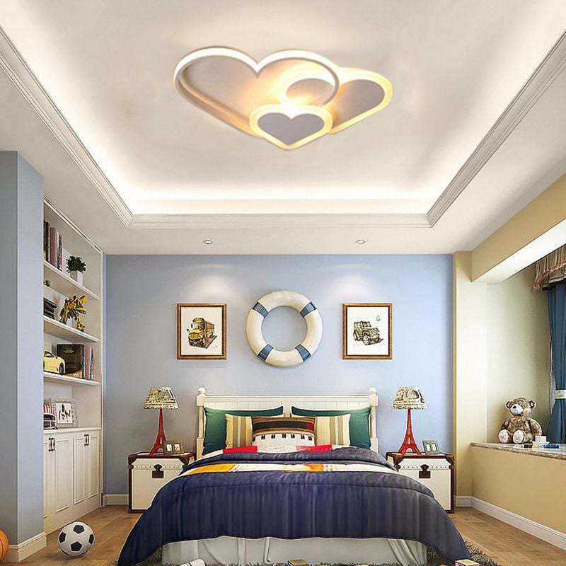 White heart-shaped Morandi ceiling light in a bedroom with framed artwork.