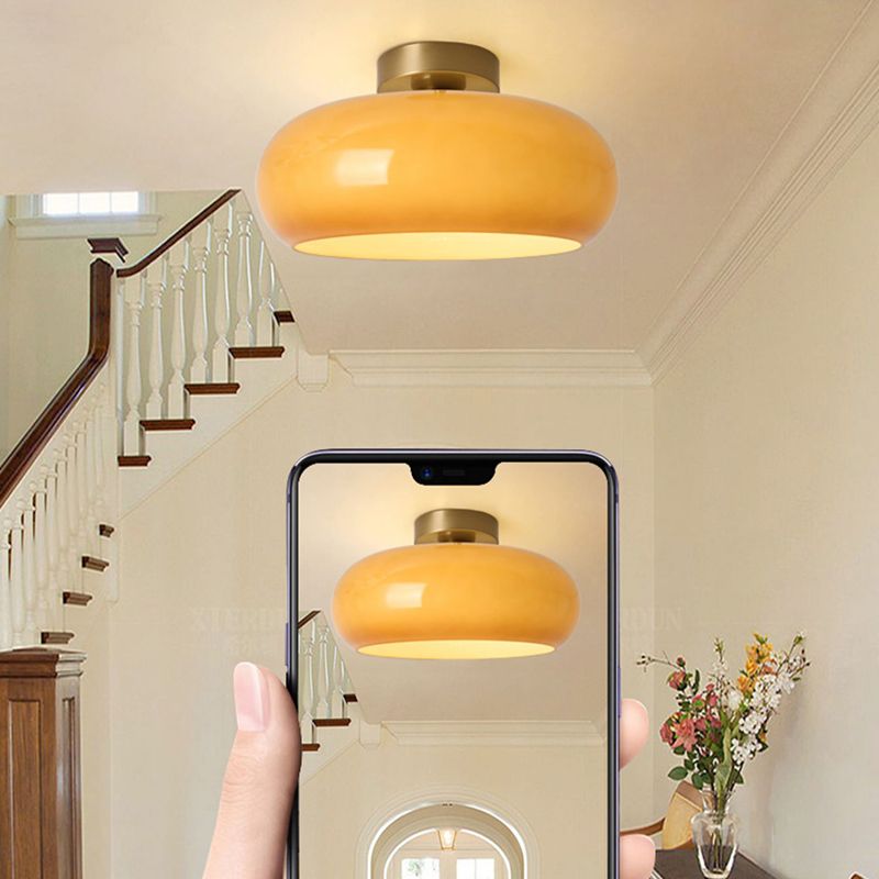 Orange Hailie close-mounted ceiling light photographed with a phone