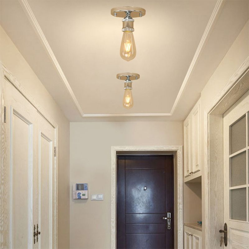 Two pale metallic Alessio exposed-bulb fittings in a cream hallway with doors and shelving, showing silver-looking holder accents.