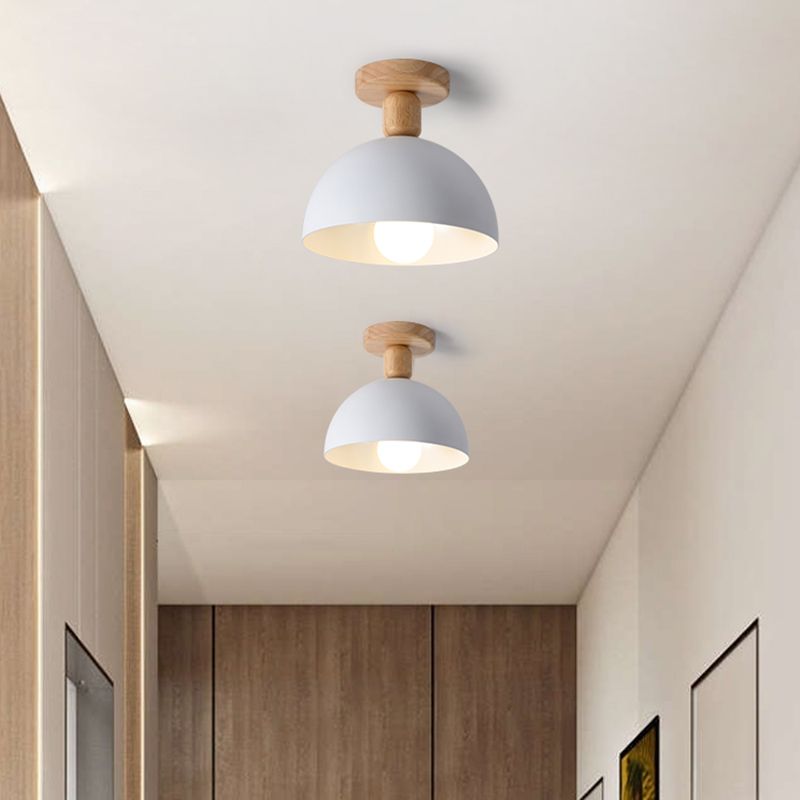 White Ozawa Dome ceiling lights along hallway with wood cabinetry, paneled end wall and two framed prints on the right