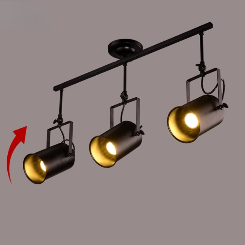 Alessio three-head black bar with illuminated spotlights, square brackets and a red direction arrow beside the left head.