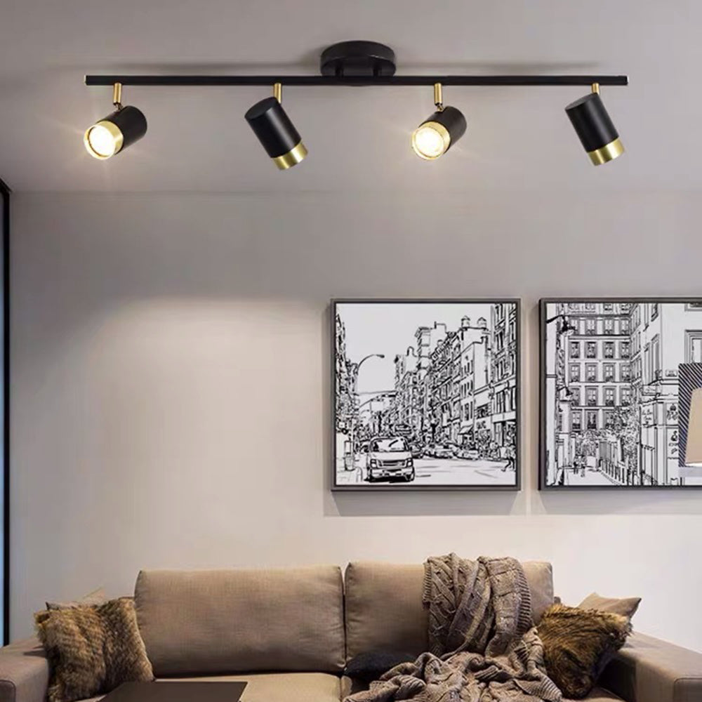 Four-head Evette bar above a beige sofa, brown cushions and a throw, with two monochrome city pictures on the wall.