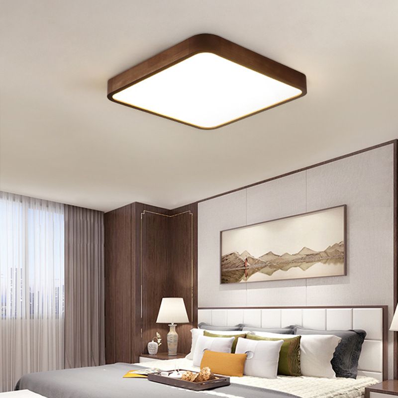 Square Style C Ozawa light with rounded corners above mountain artwork, a panelled headboard, brown wall panels and a bedside lamp.