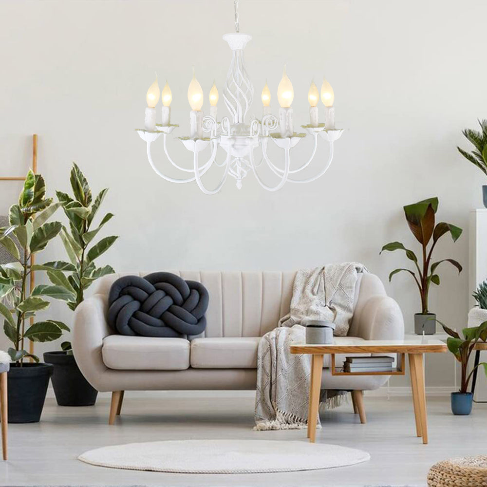 White Silva eight-light chandelier above white sofa with dark knotted cushion, coffee table and houseplants