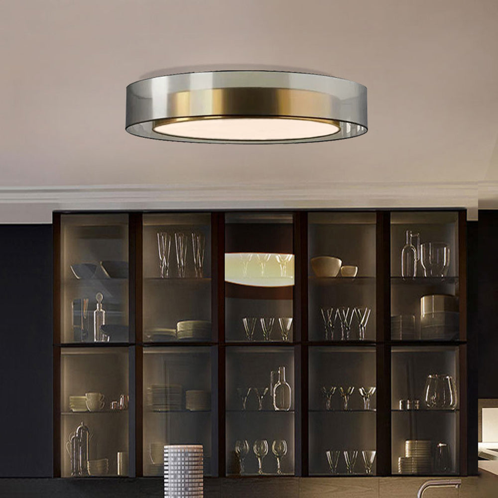 Quinn gold-inner, grey-outer ceiling light above dark glazed cabinets displaying glasses and dishes, with a tap at the lower edge.