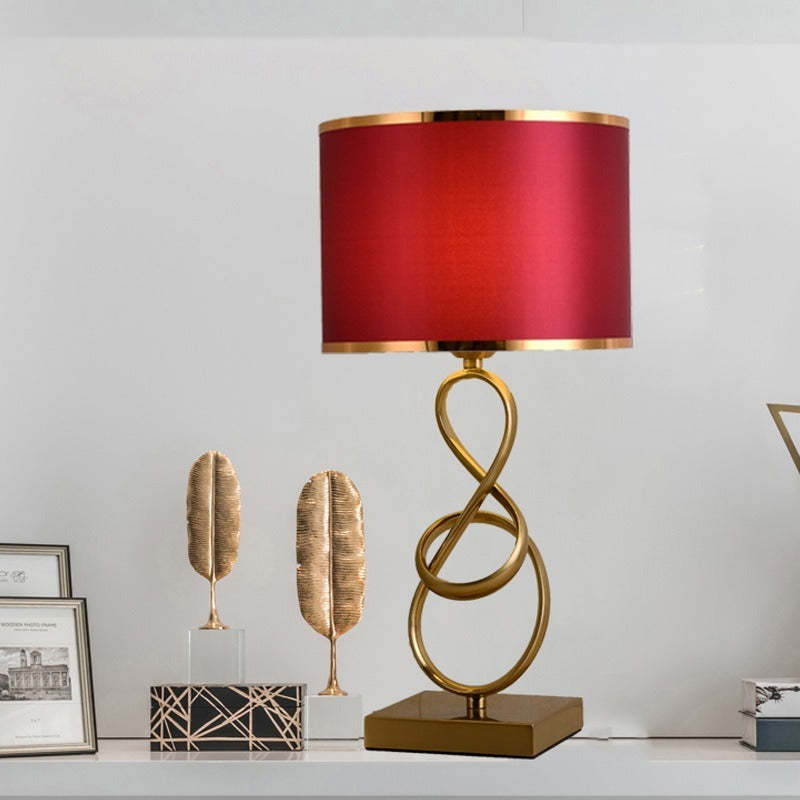 Red Sano table lamp with a square base on a cabinet