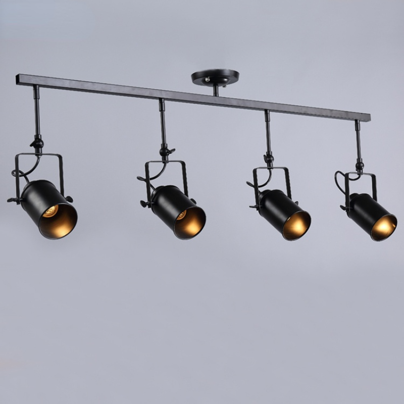 Alessio four-head fixture on pale-grey backdrop, with downward-facing openings, square brackets and visible looped cables.