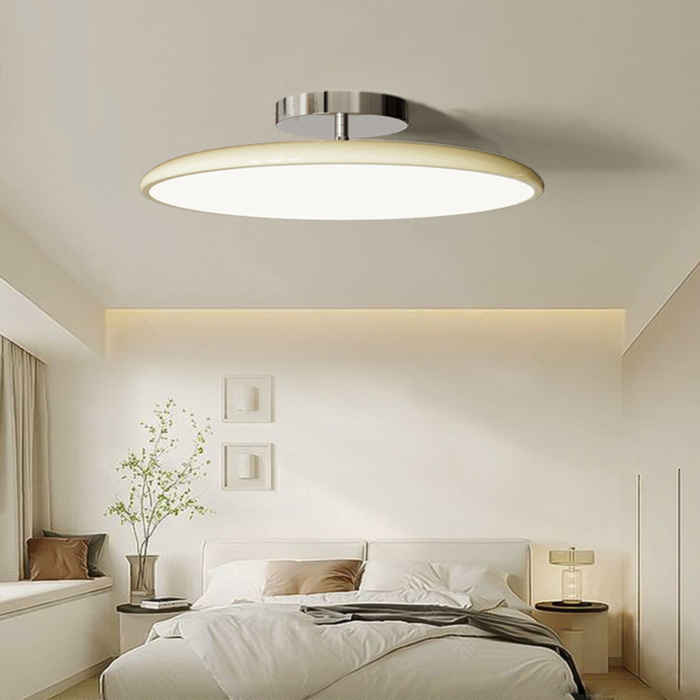 Cream Valentina ceiling light in a neutral bedroom above a light upholstered bed.