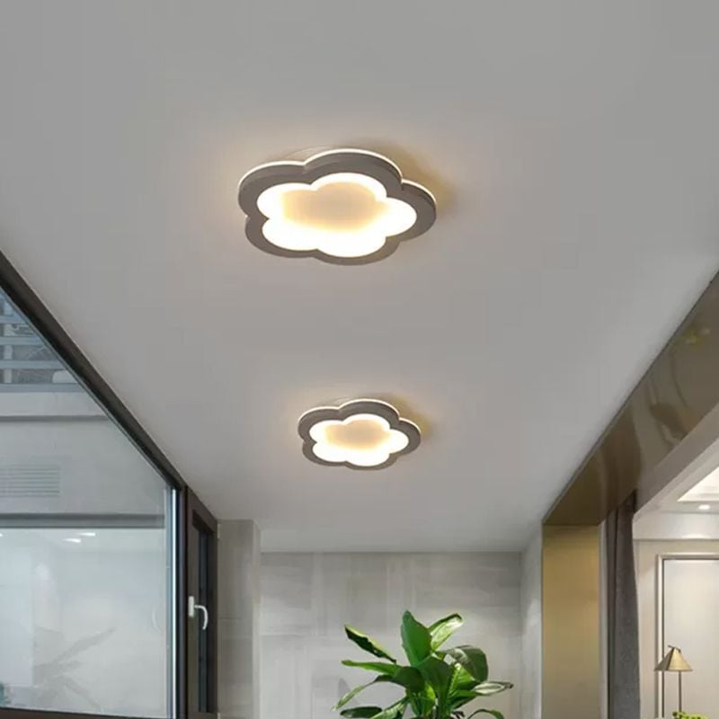 Two five-lobed flower ceiling lights with gray borders and yellow-lit inner outlines
