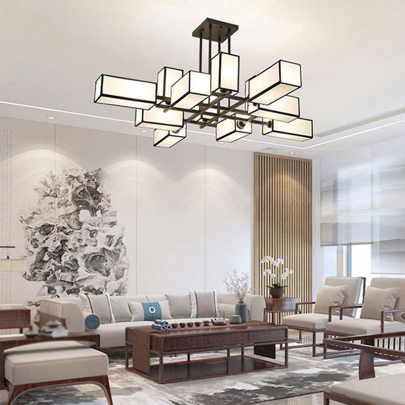 Wide Black Lacey chandelier above a long seating arrangement