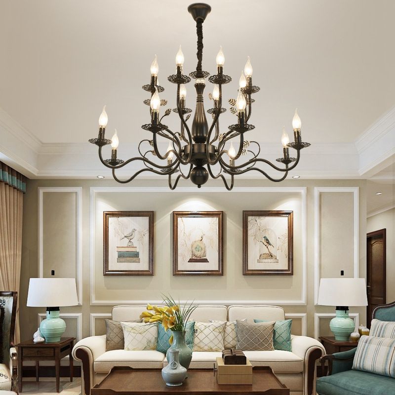 Black 16-Light Marilyn above a cream sofa and wood coffee table, with pale green table lamps, framed pictures and paneled walls.