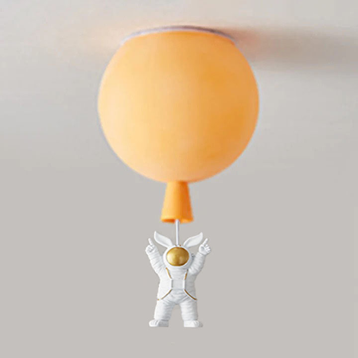 Orange balloon globe with a tapered lower detail and a both-arms-up white astronaut below a pale link.
