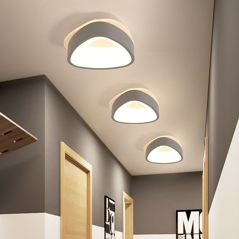 Three gray Quinn triangular ceiling lights along a hallway