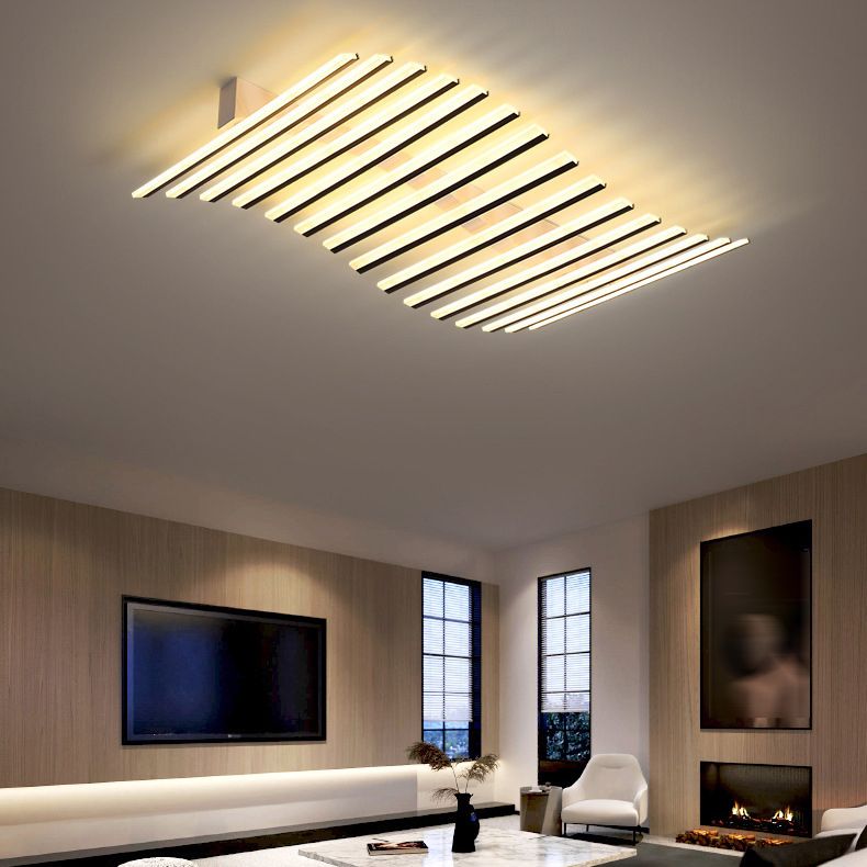 Quinn staggered light bars in a living room with a television, fireplace, narrow window blinds, white chair and marble table.