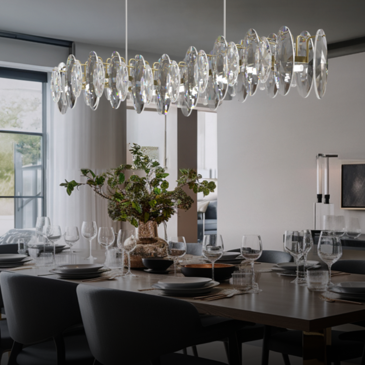 Close view of Olivia glass discs on a gold-tone linear frame above a dining arrangement.