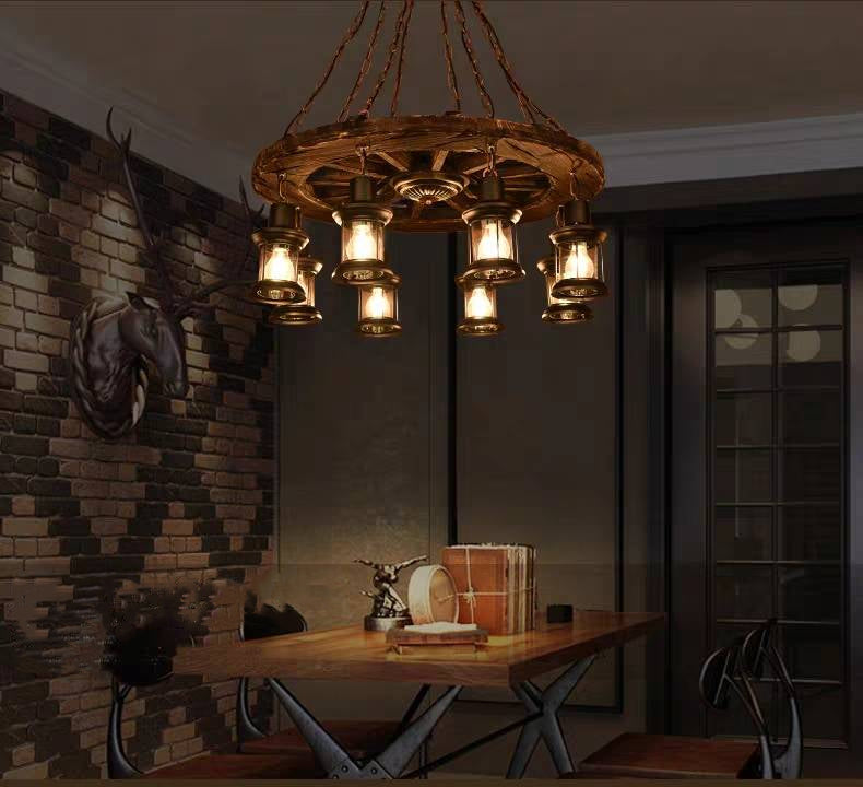 Illuminated Austin wagon-wheel fixture above a wooden dining table.