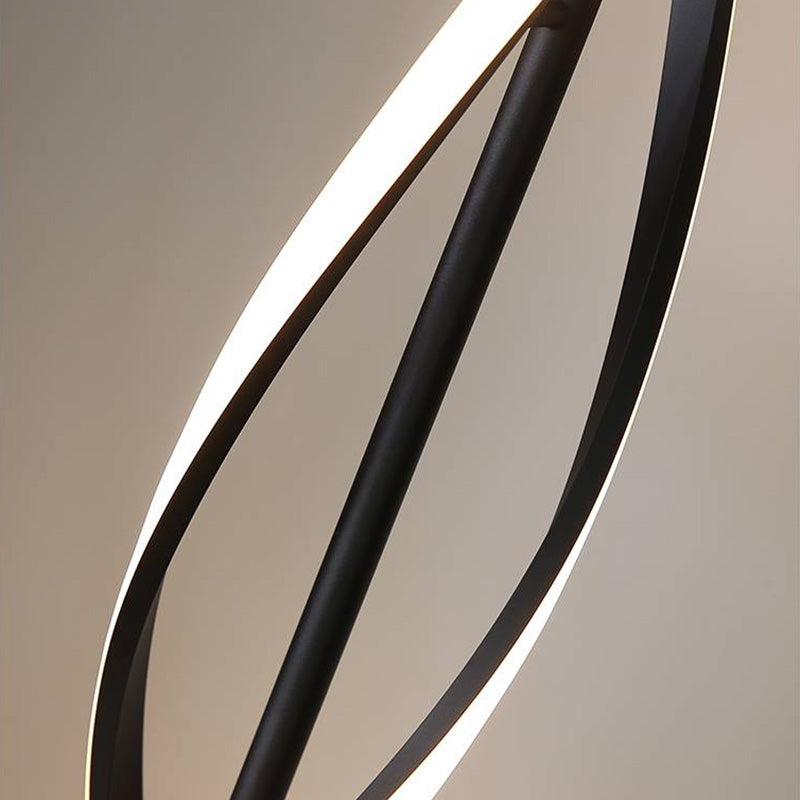 Angled detail of two curved illuminated strips crossing around the black central stem
