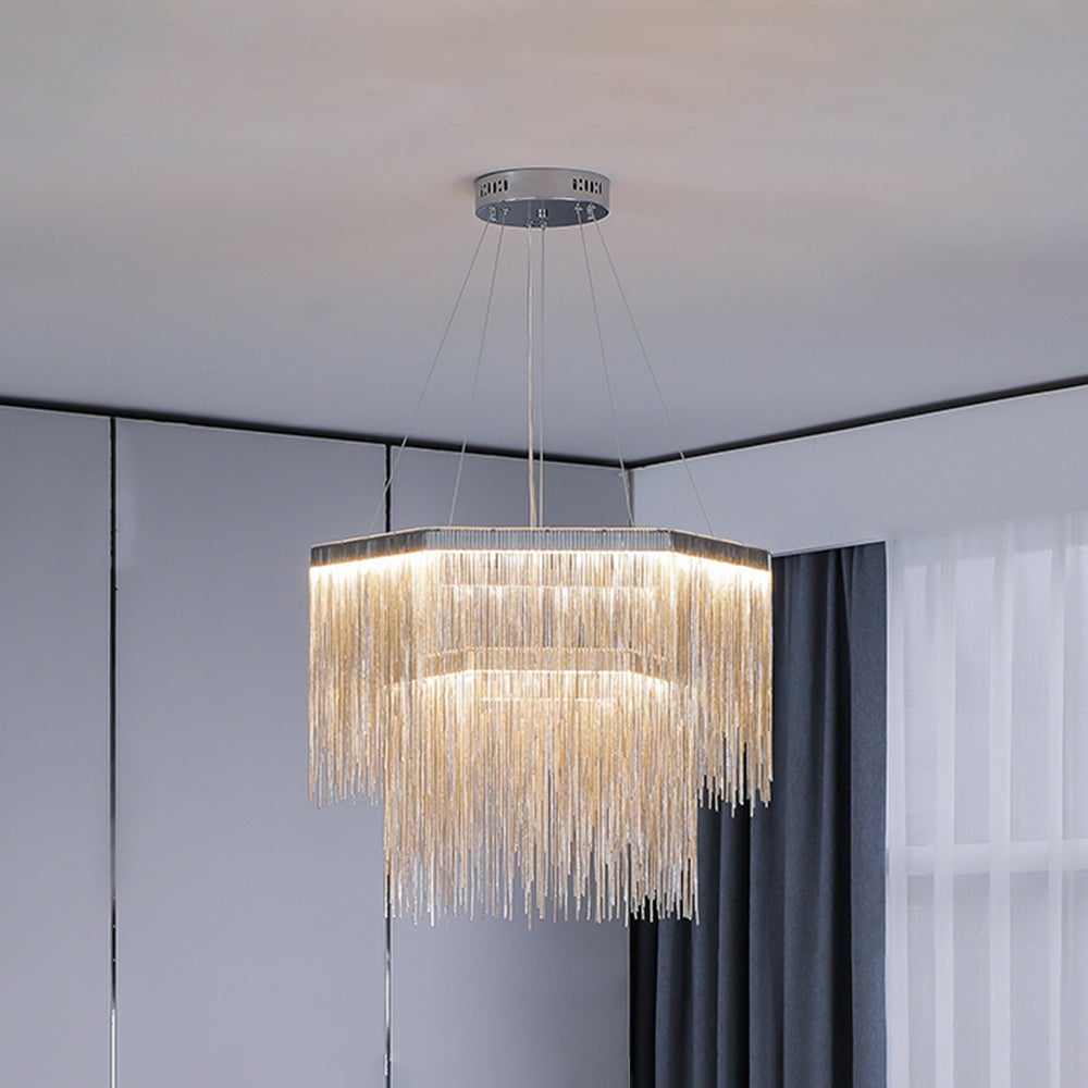 Silver two-tier Colon pendant illuminated near dark curtains